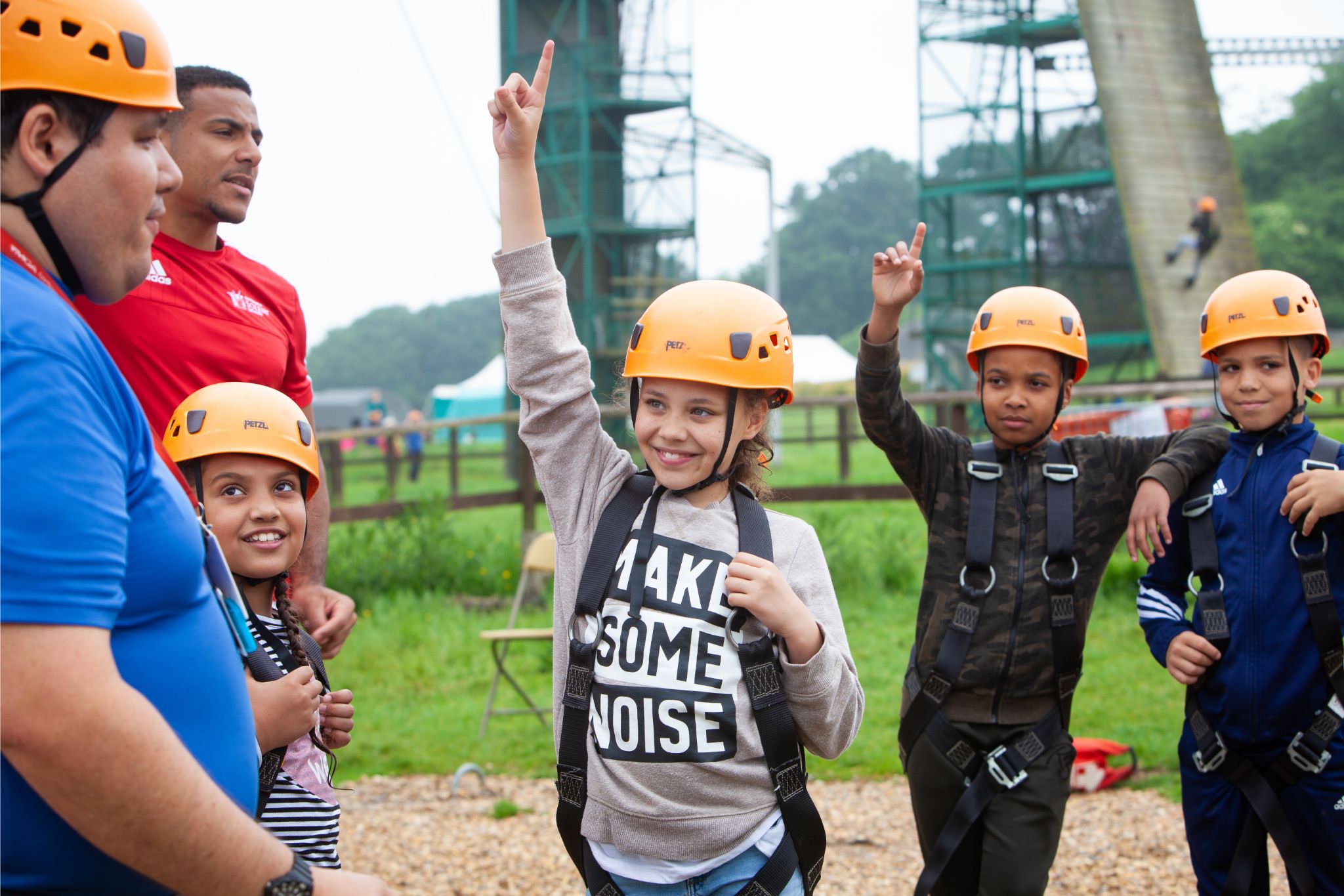 Children in helmets taking part in outdoor activities at a YMCA Fairthorne day camp