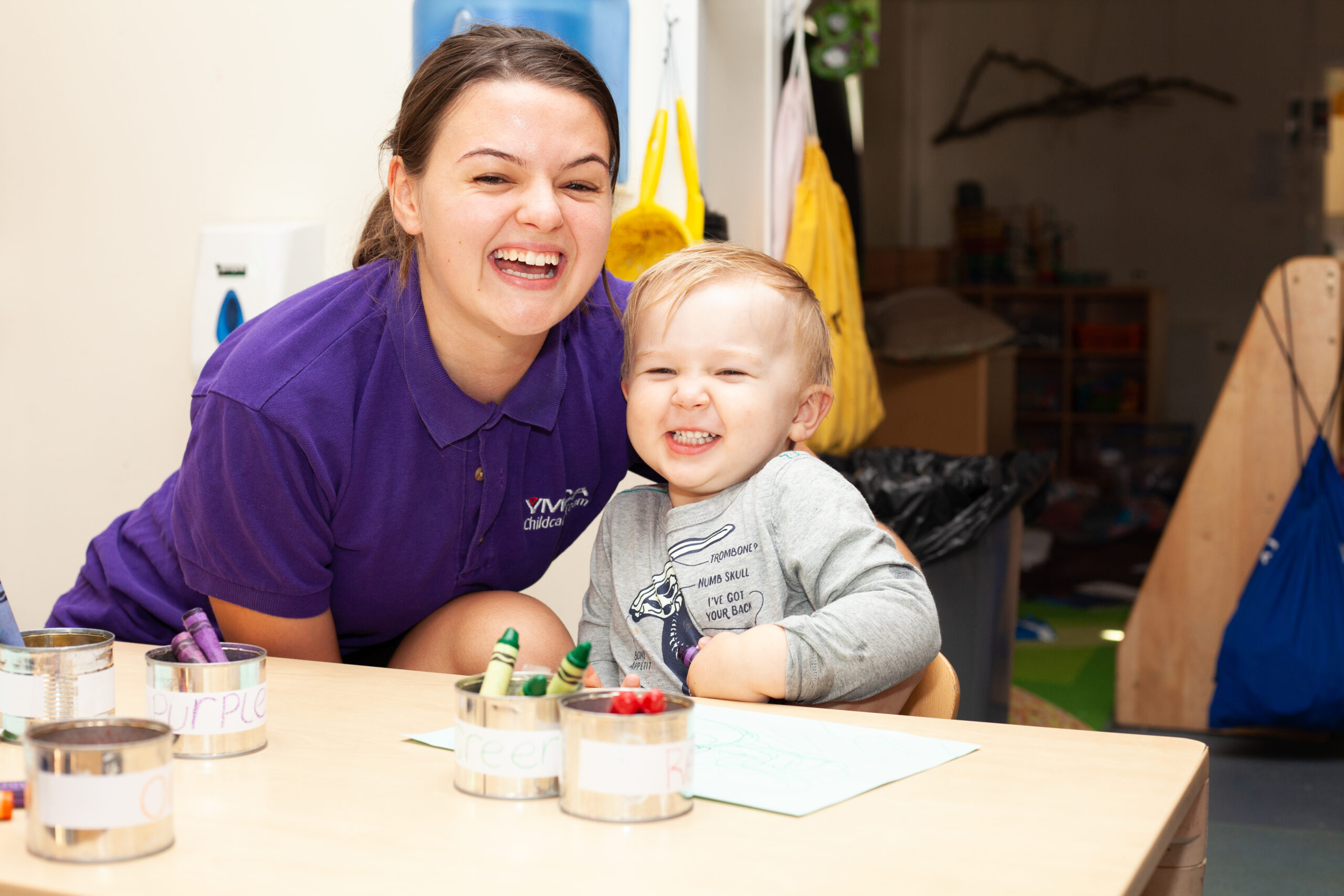 Whale Island Nursery smiling a cheesy grin with child