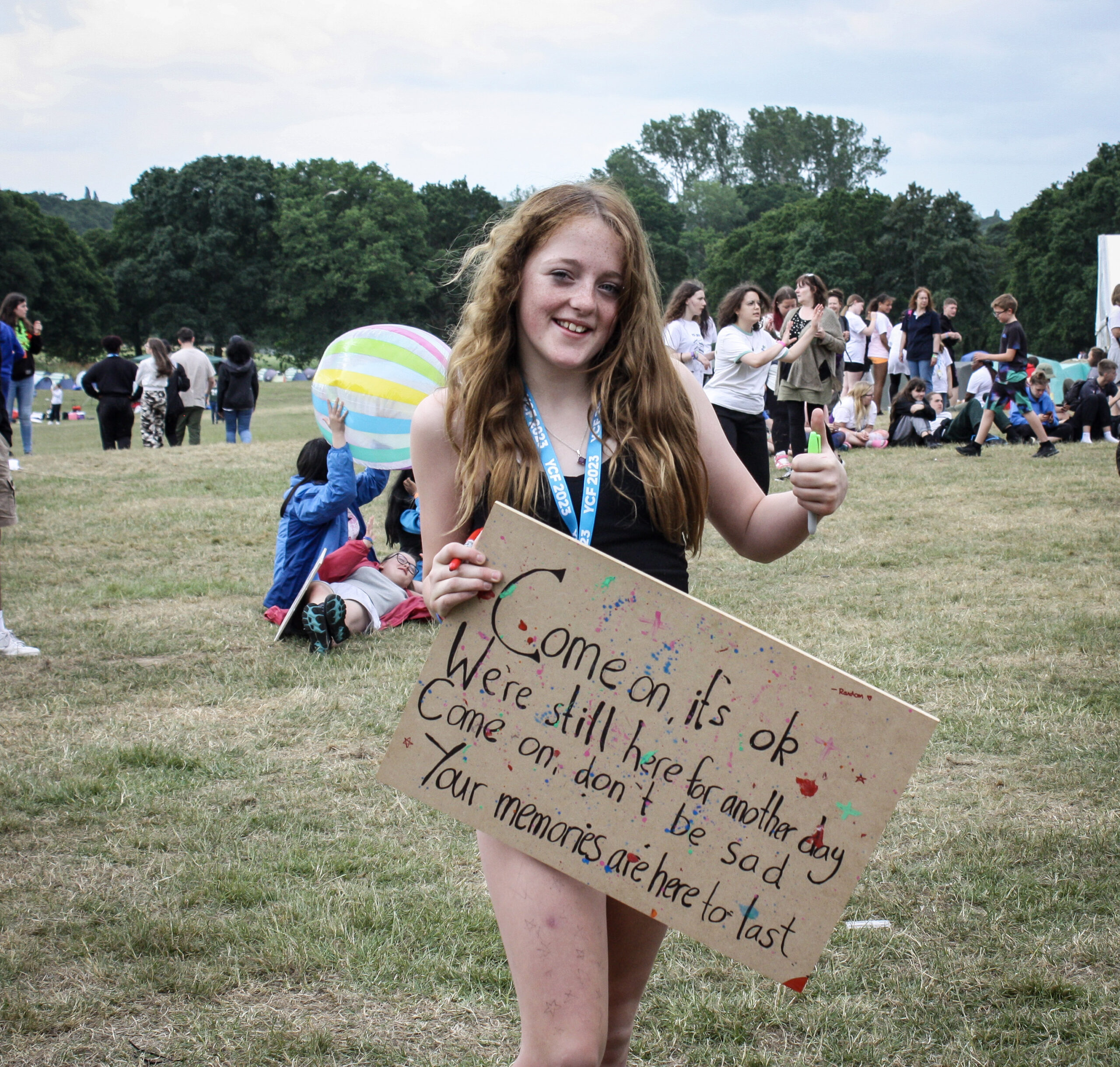 Younger carer at ycf holding a sign