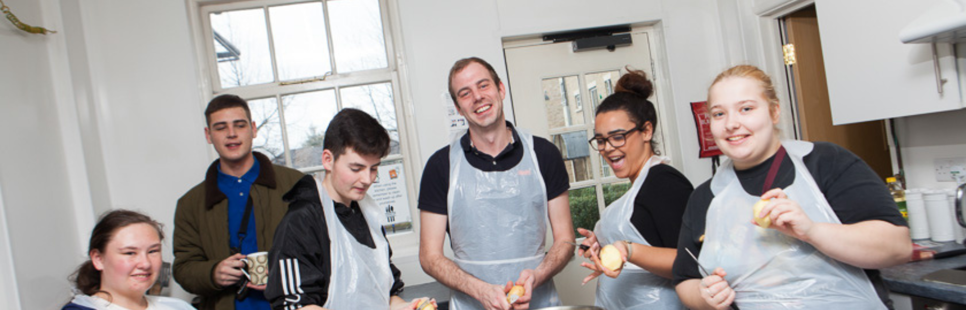 Young people cooking together in a YMCA housing kitchen